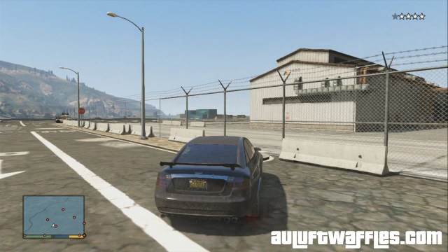 Drive through the gap between the concrete blocks.